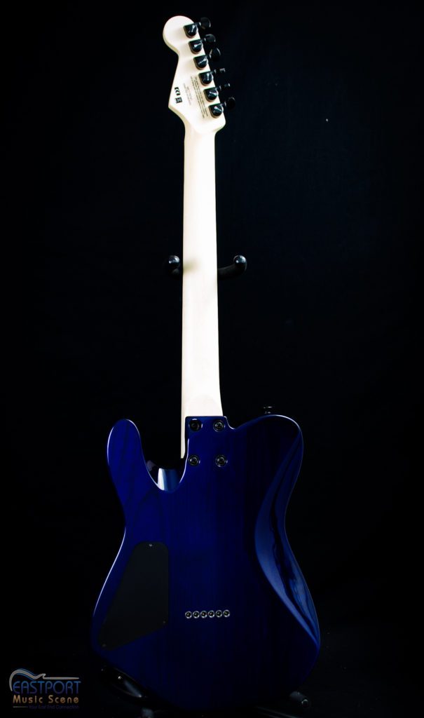 A blue electric guitar with white strings and black back.