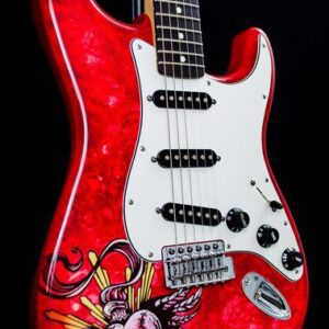 A red guitar with some drawings on it