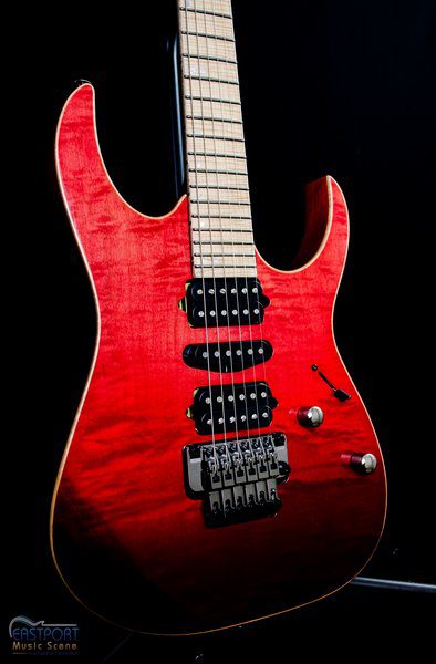 A red guitar with black trim and strings.