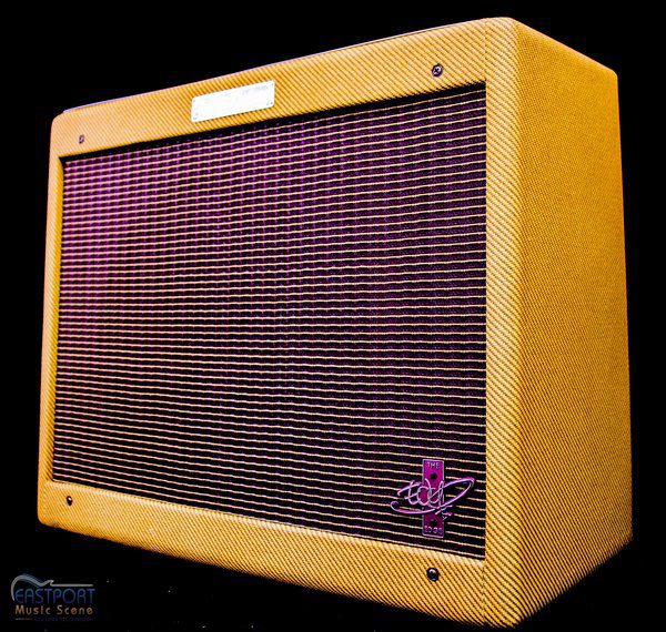 A guitar amplifier with the front panel open.
