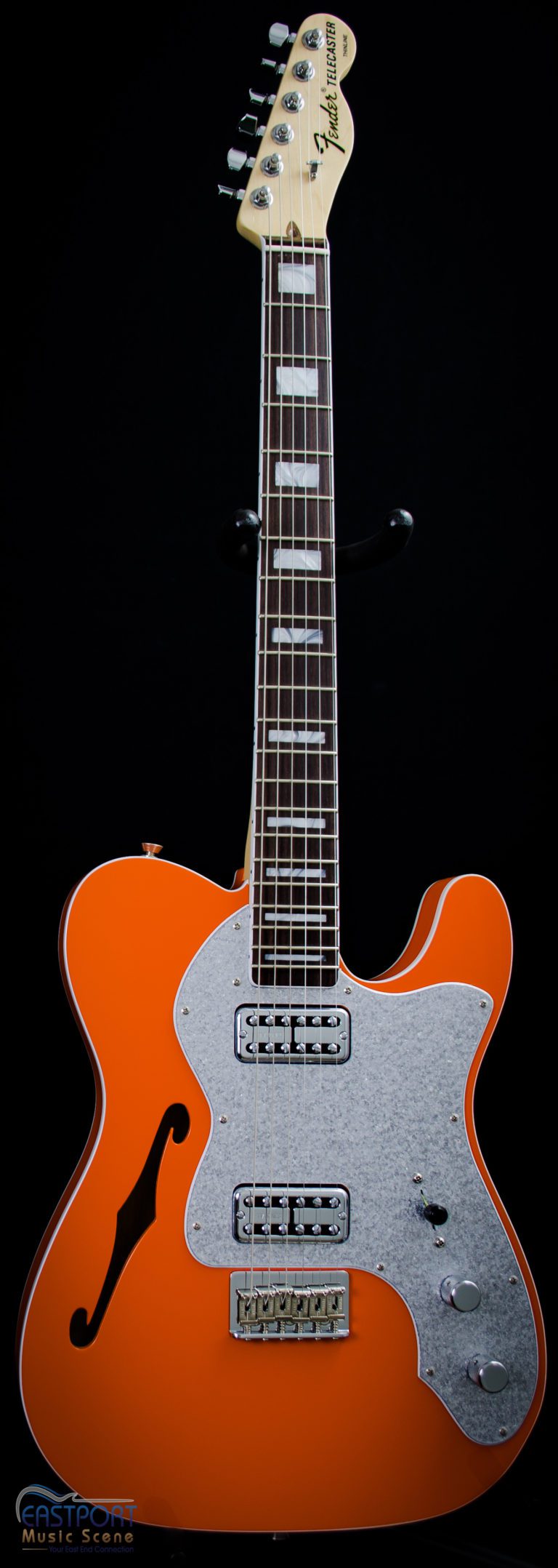 A orange electric guitar with an eight string