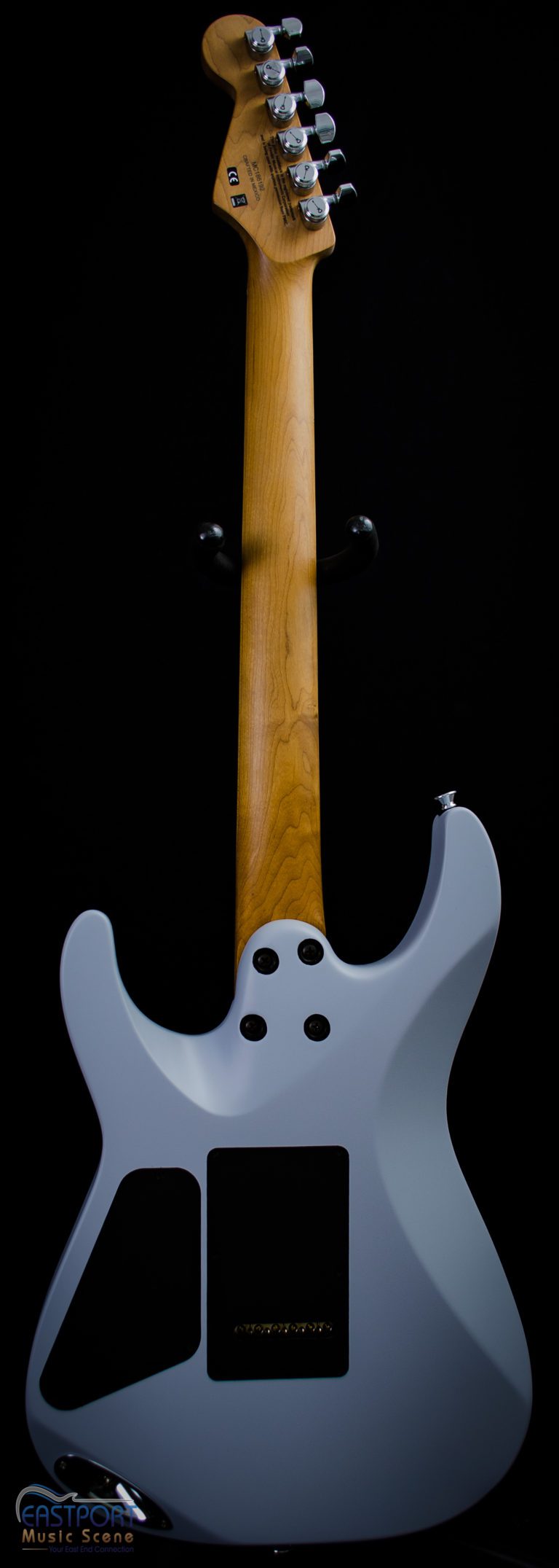 A close up of the neck and head of an electric guitar.