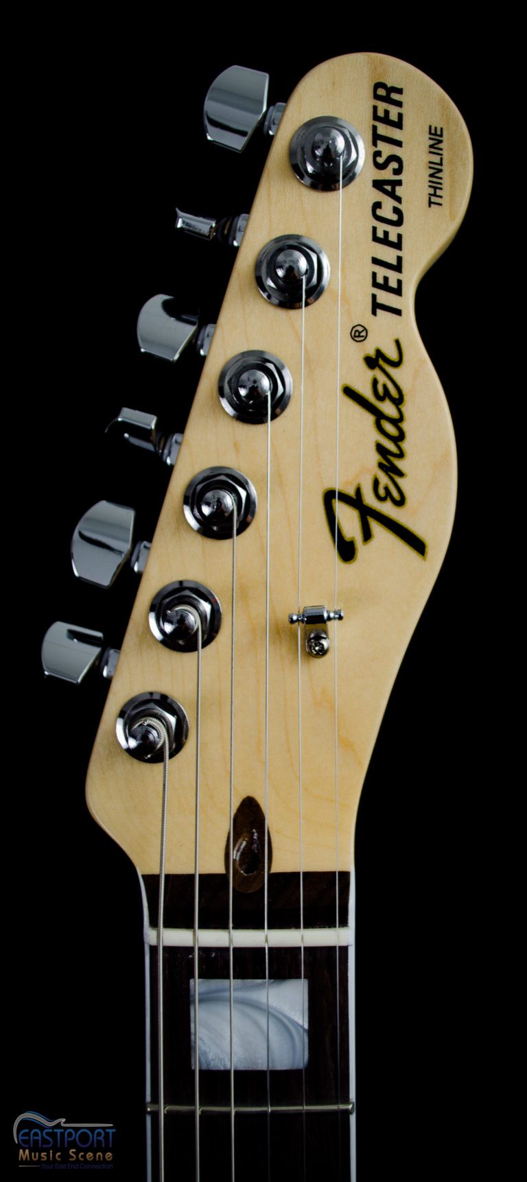 A close up of the headstock on an electric guitar.