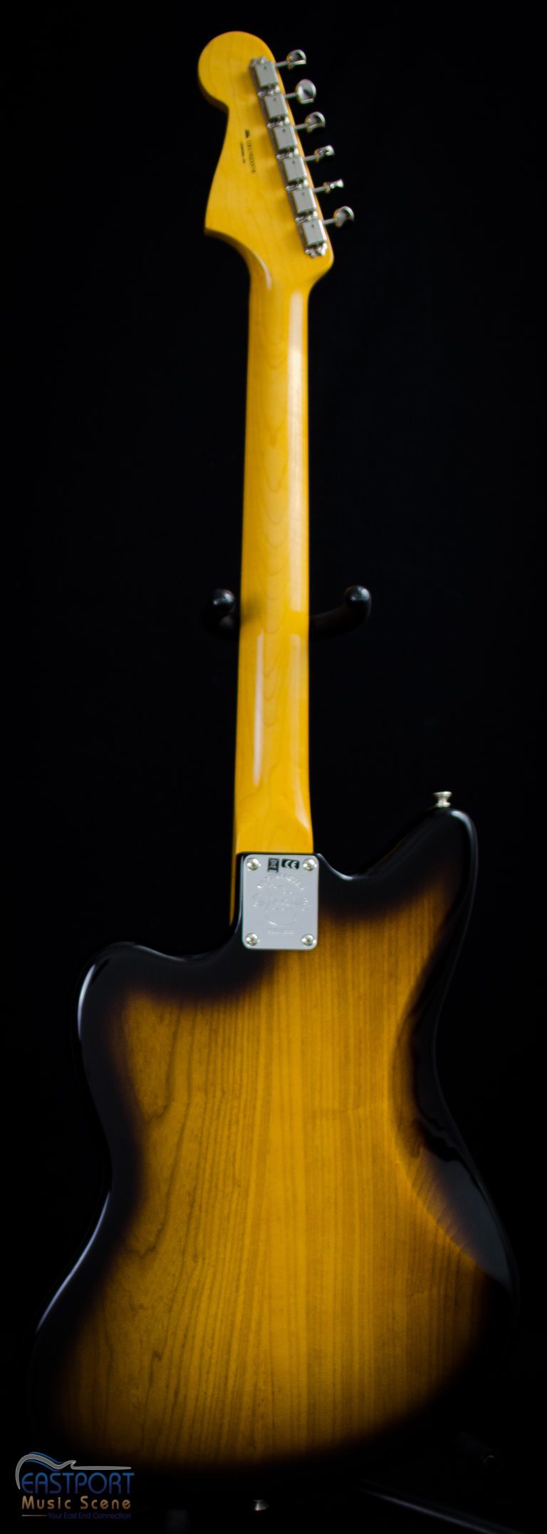 A guitar with an electric yellow neck.