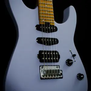 A close up of the neck and body of an electric guitar.