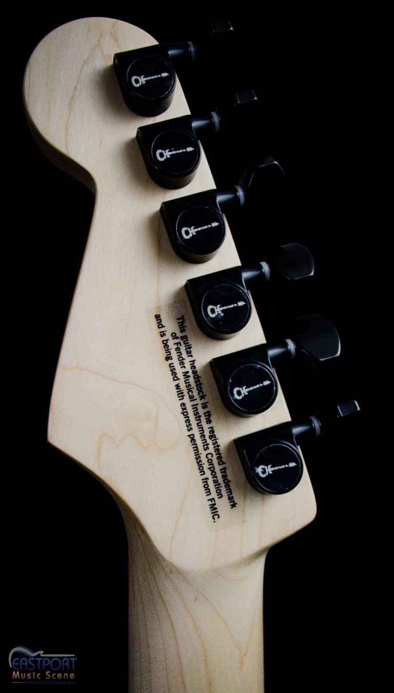 A guitar with six black buttons on it.