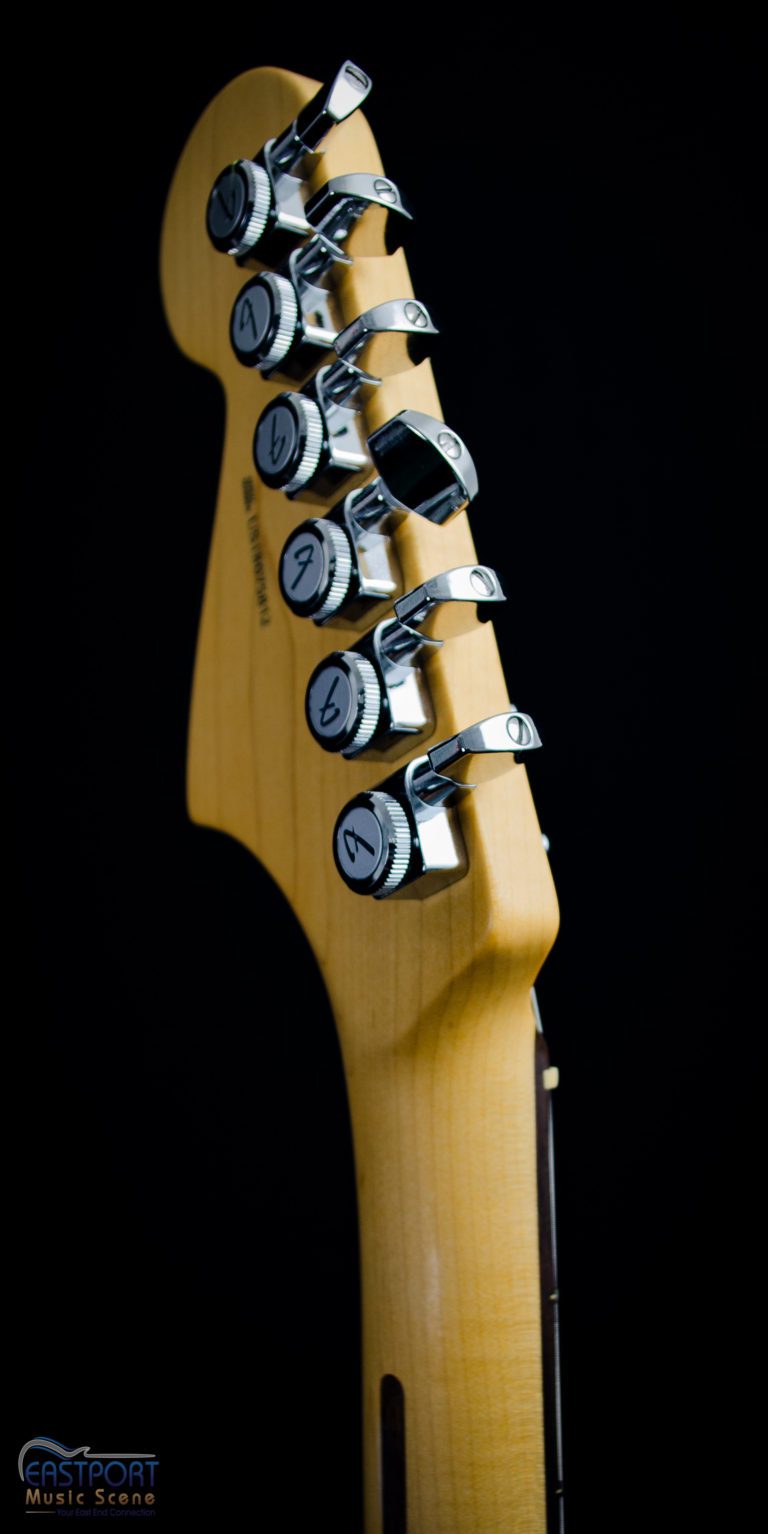A guitar with many knobs and buttons on it