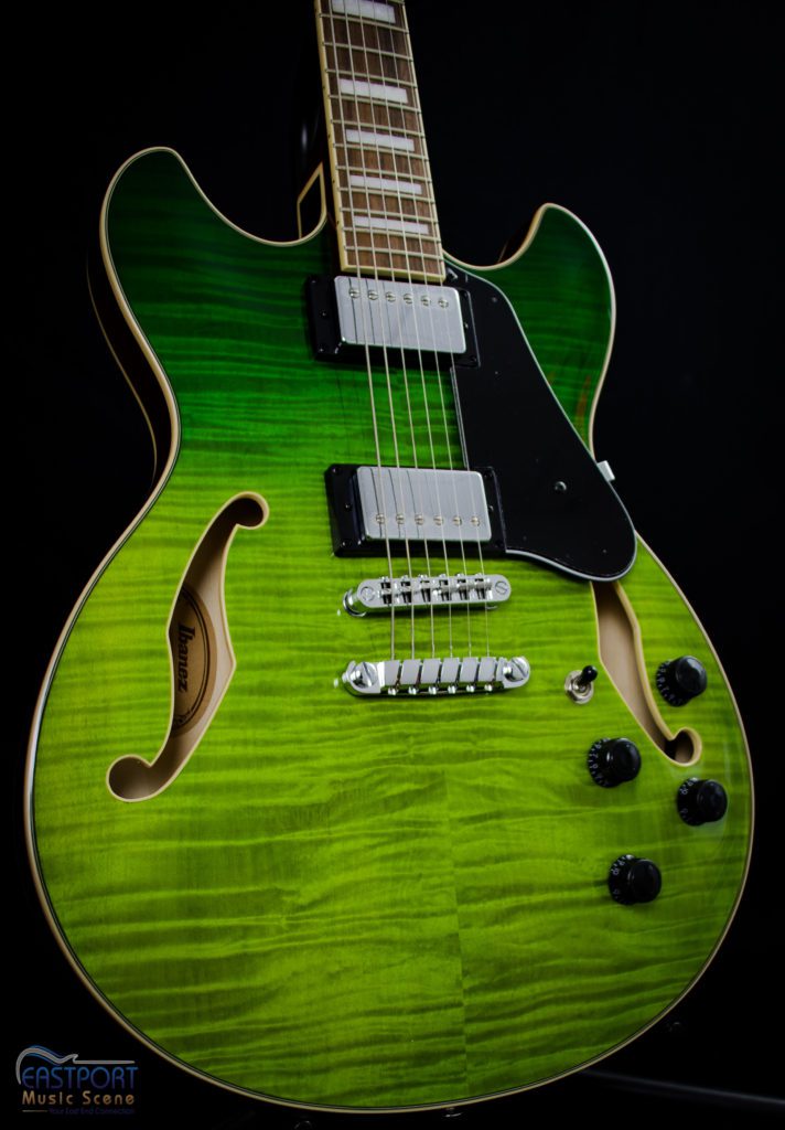 A green electric guitar with black accents.