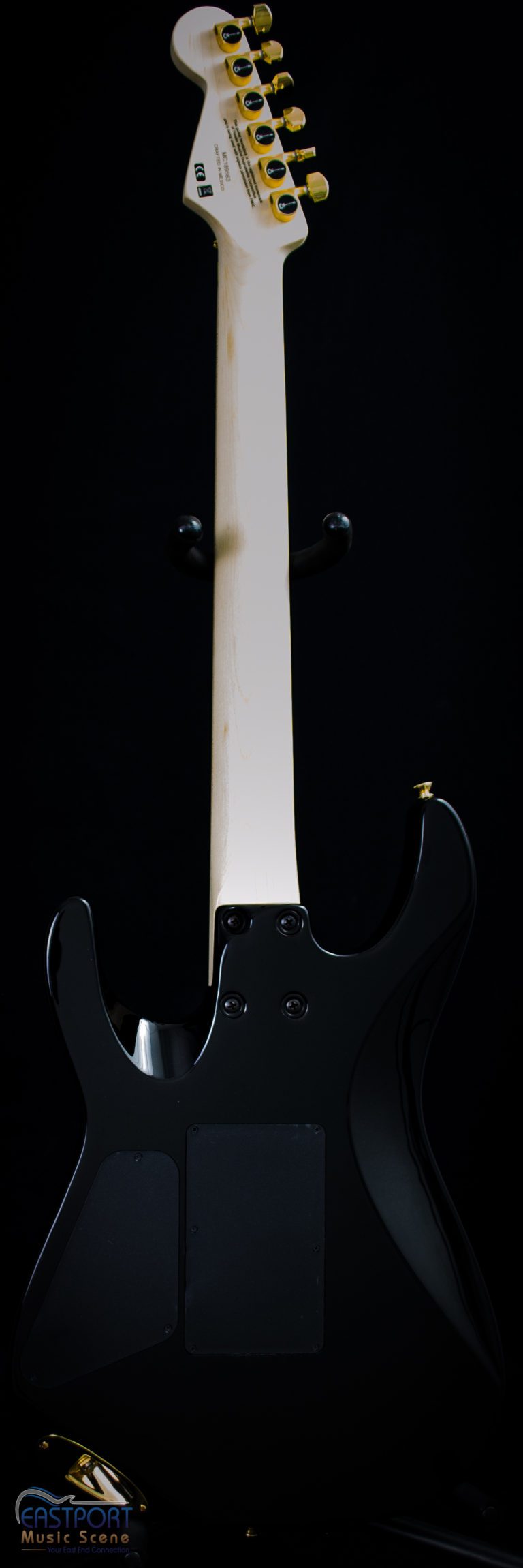 A black electric guitar with white neck and back.