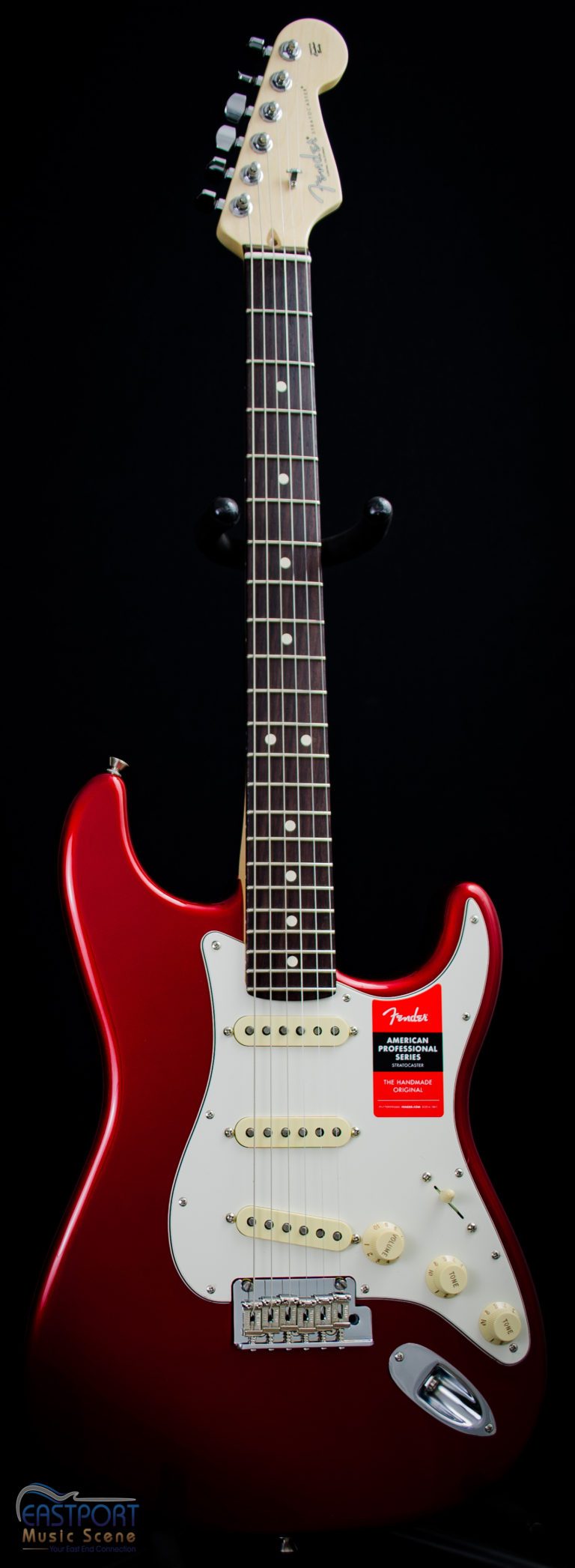 A red electric guitar with white and black fretboard.