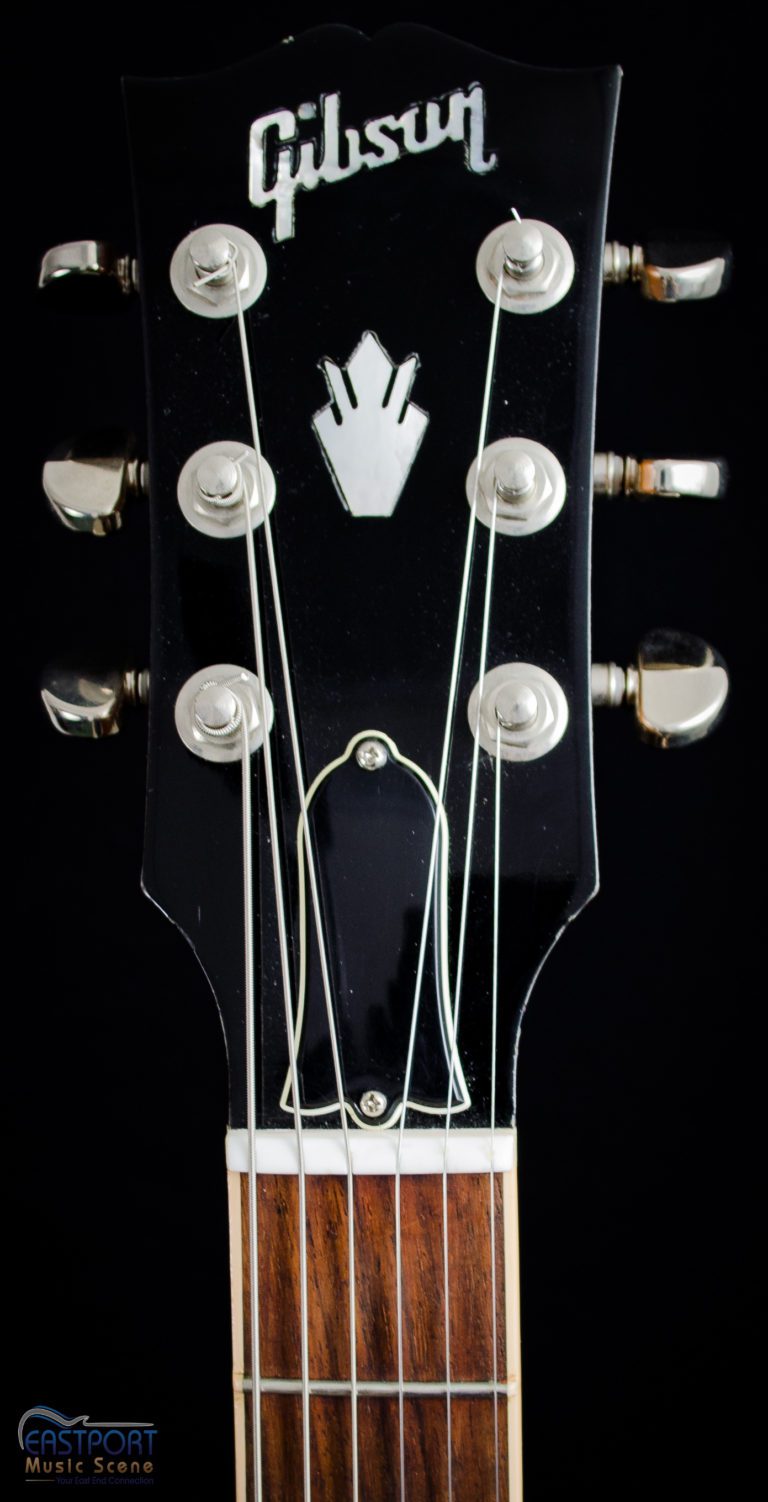 A close up of the strings on an electric guitar