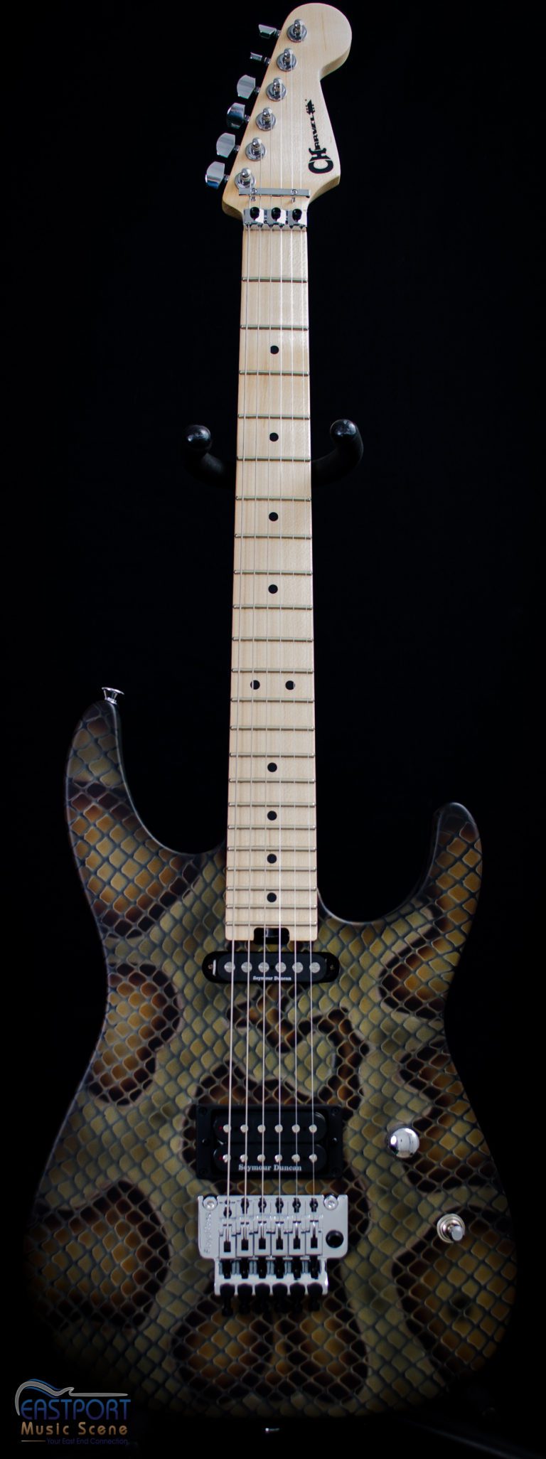 A guitar with a pattern of black and brown.