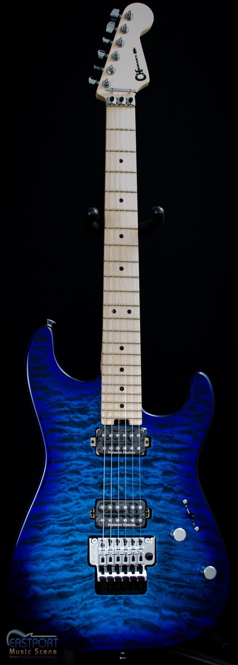 A blue electric guitar with white strings and black body.