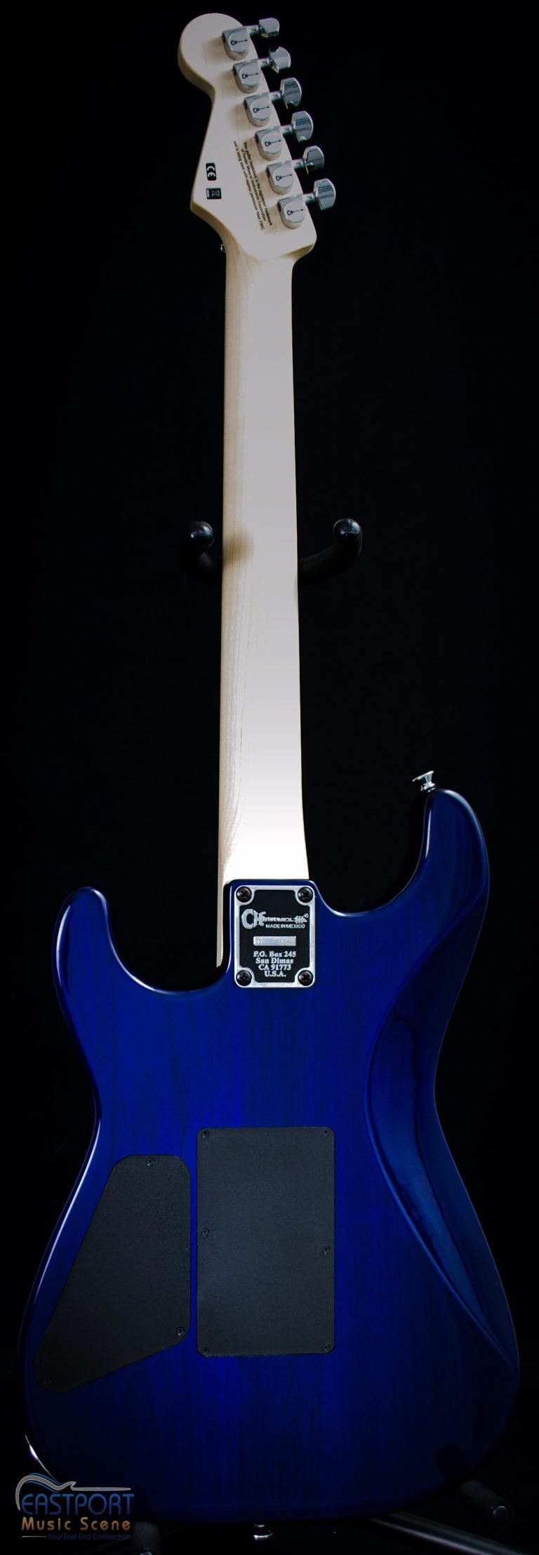 A blue electric guitar with white strings and black headstock.