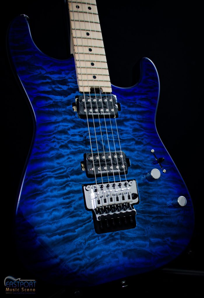 A blue electric guitar with black stripes on it.