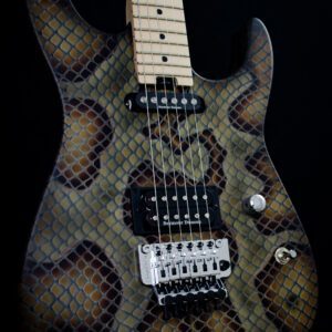 A guitar with a snake skin pattern on it.