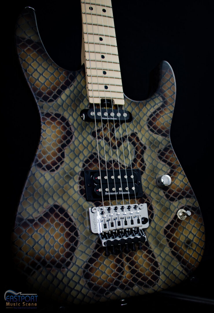 A guitar with a snake skin pattern on it.