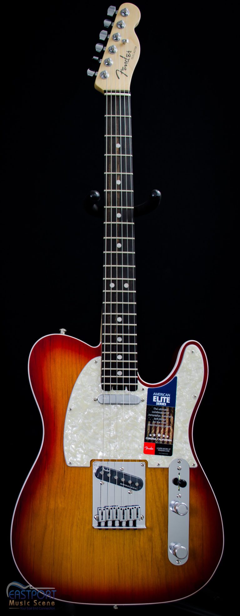 A guitar with the strings missing is shown.