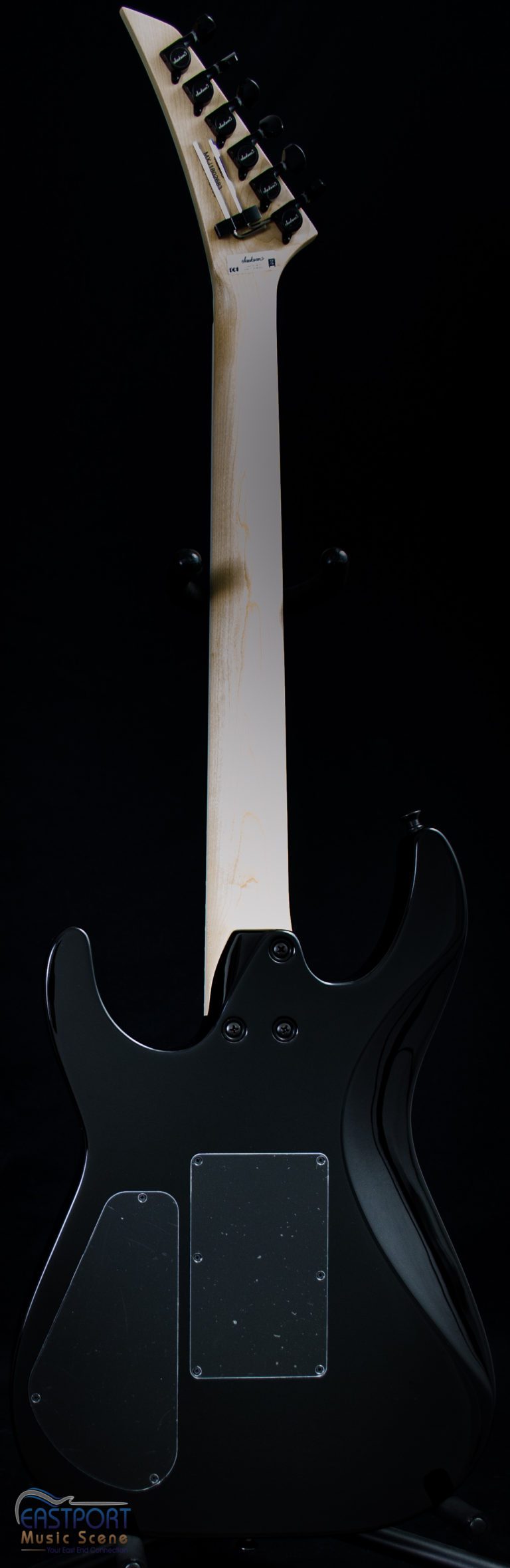 A black guitar with white trim and a white handle.