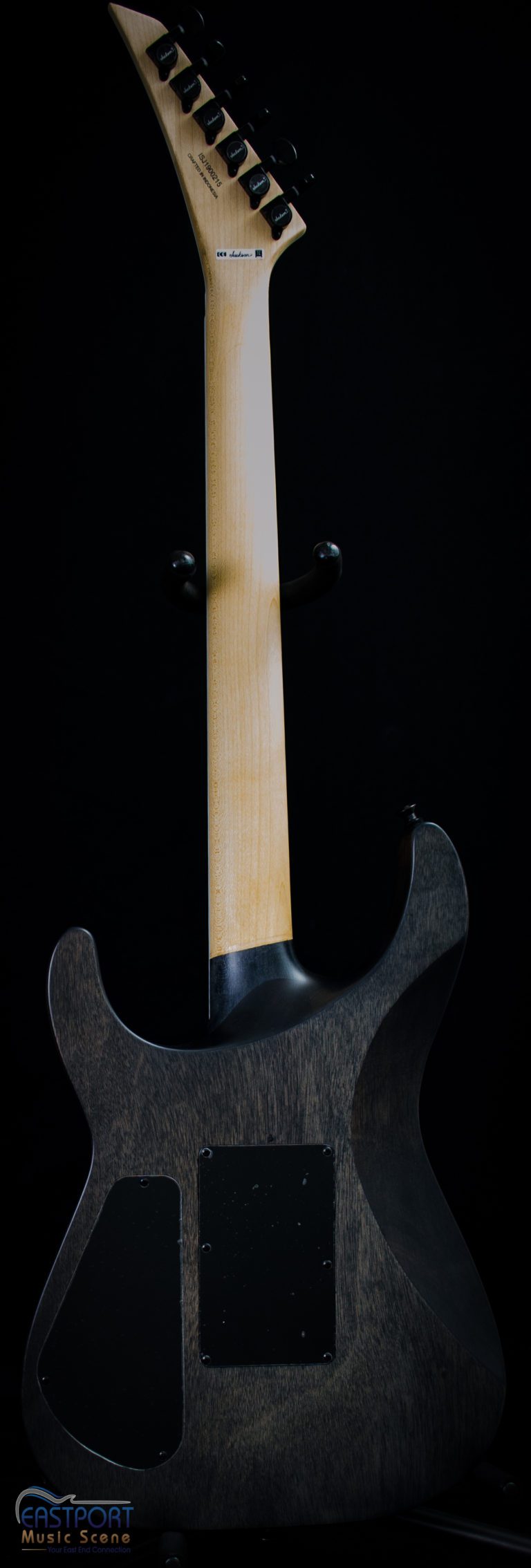 A guitar with a black handle and white neck.