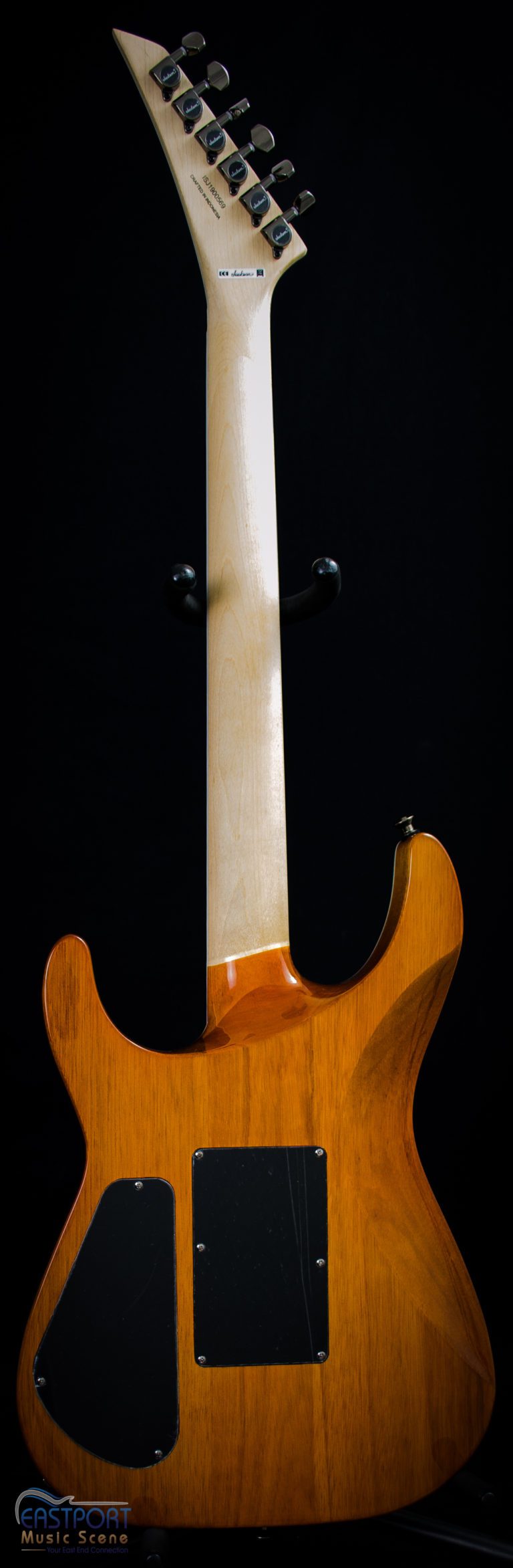 A guitar with the neck turned to show its front end.