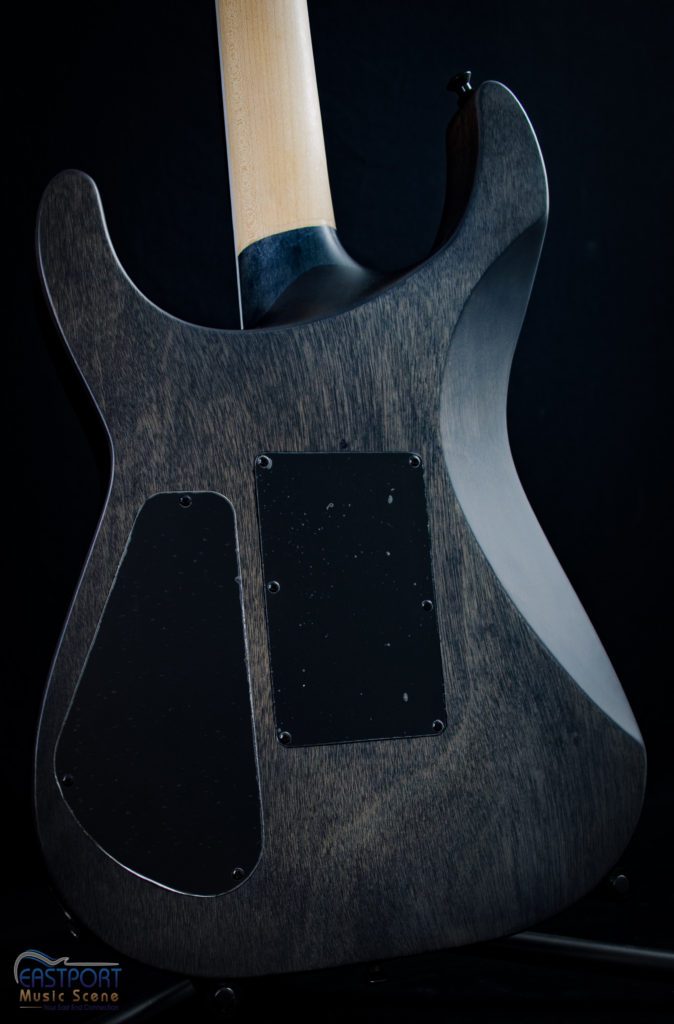 A guitar with a black finish and a white neck.