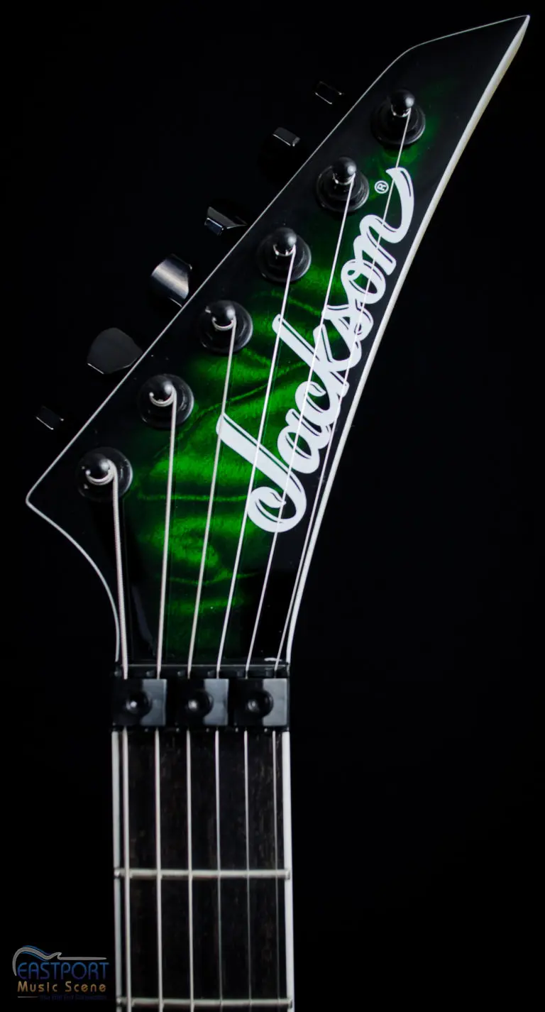A close up of the neck and headstock of an electric guitar.
