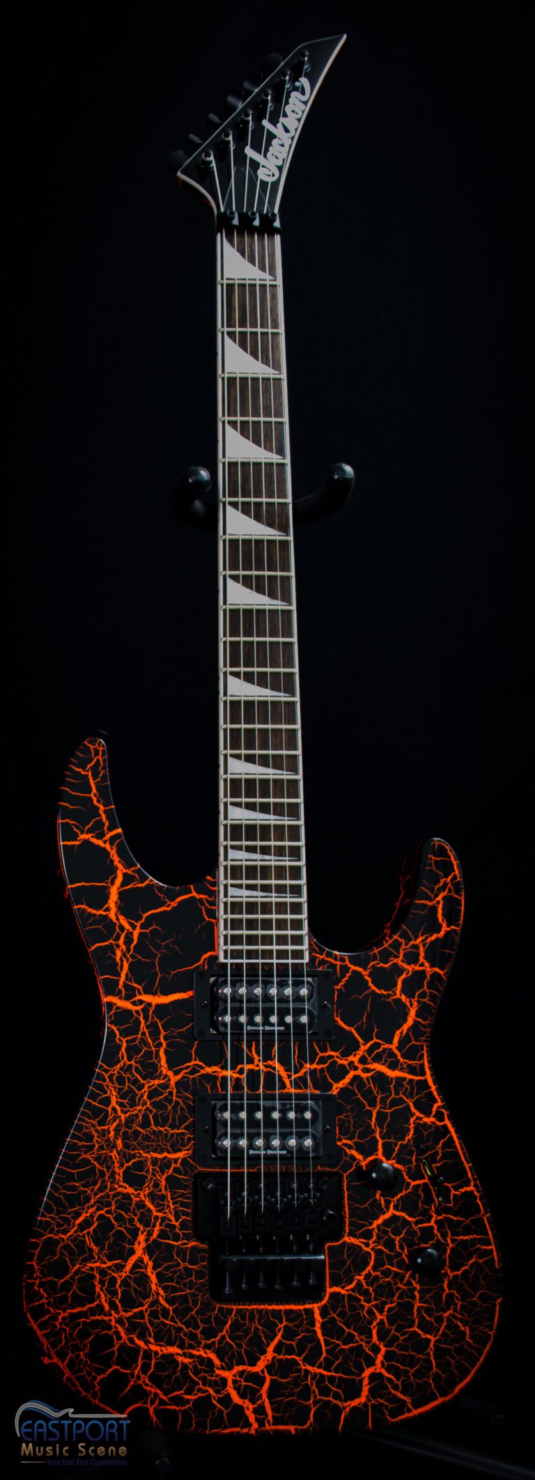 A guitar with some orange and black flames on it