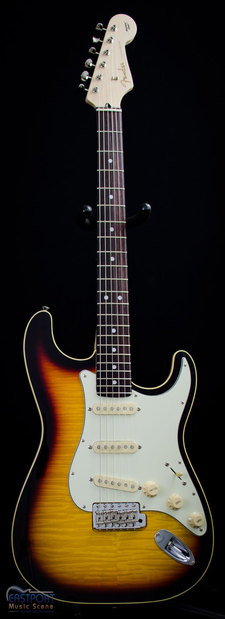 A guitar is shown with the strings missing.