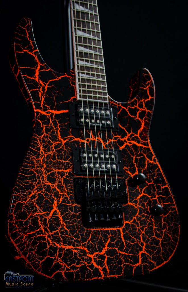 A guitar with red and black flames on it.