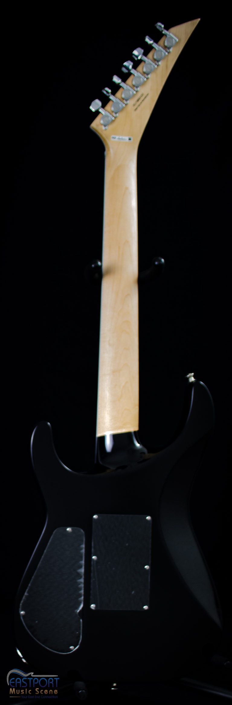A black guitar with a white handle and a black neck