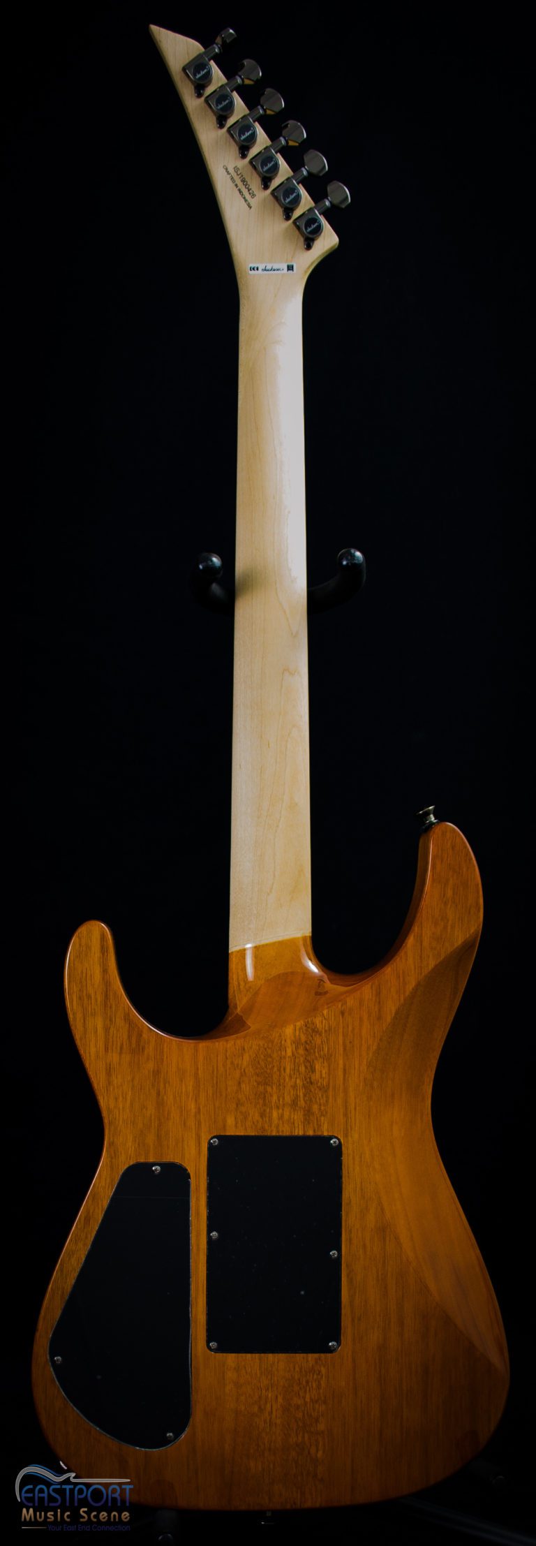 A guitar with the neck and headstock turned to the side.