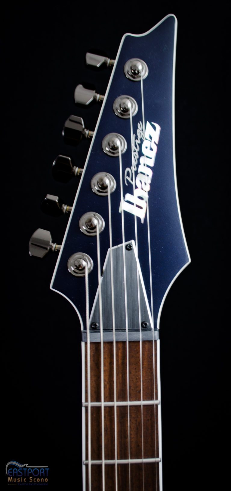 A close up of the headstock on an ibanez guitar.