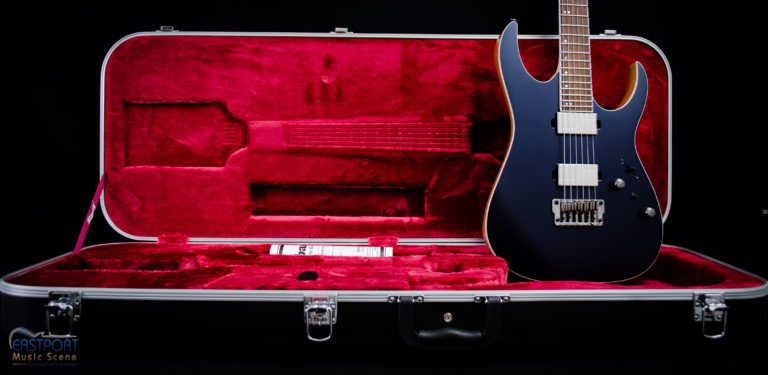 A guitar case with an electric guitar inside of it.