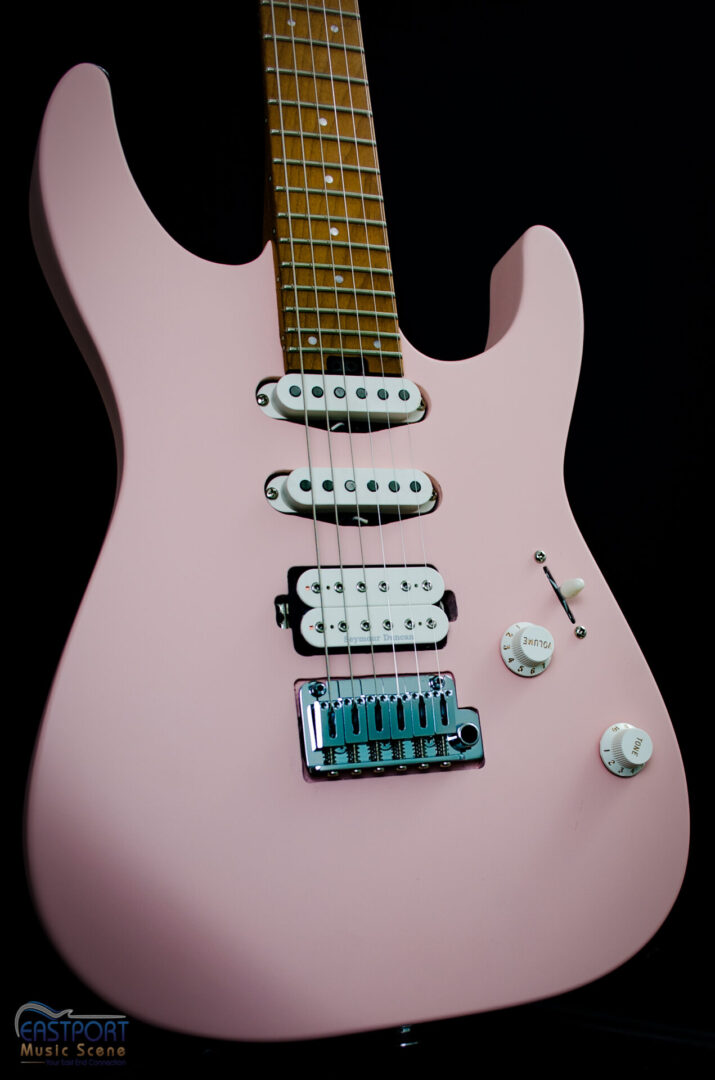 A pink electric guitar with the strings and bridge missing.