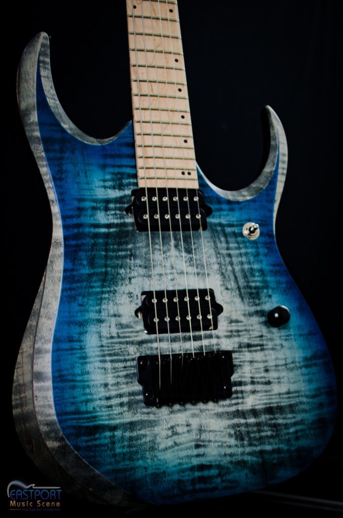 A blue guitar with a white face and black trim.