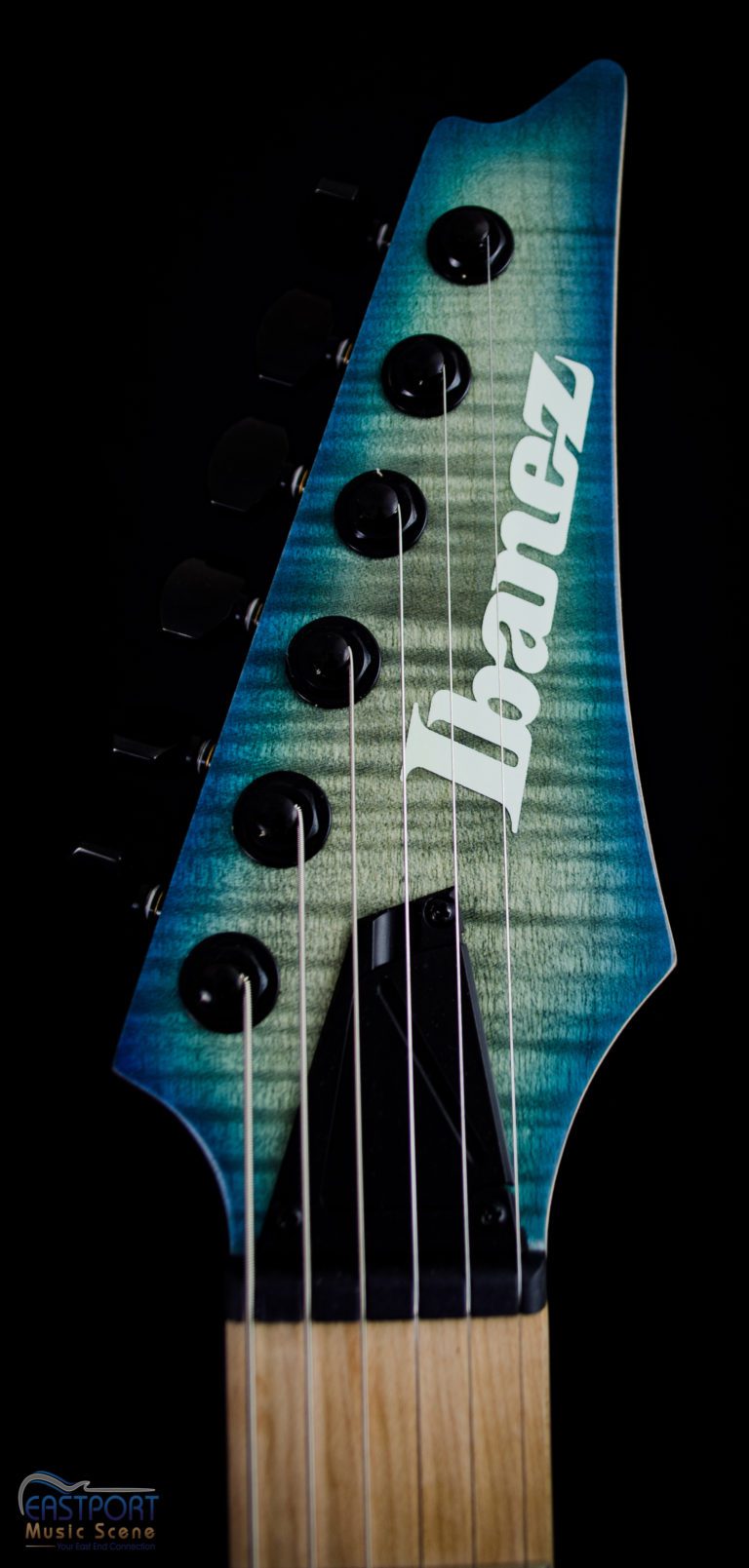 A close up of the neck and headstock of an ibanez guitar.