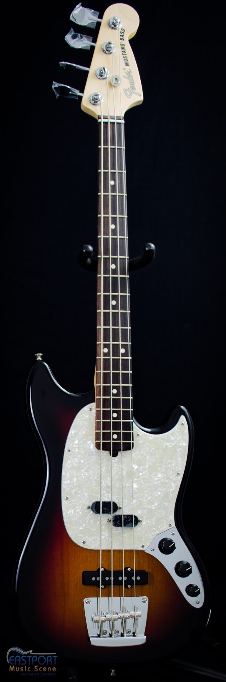 A black and white guitar is in front of a black background