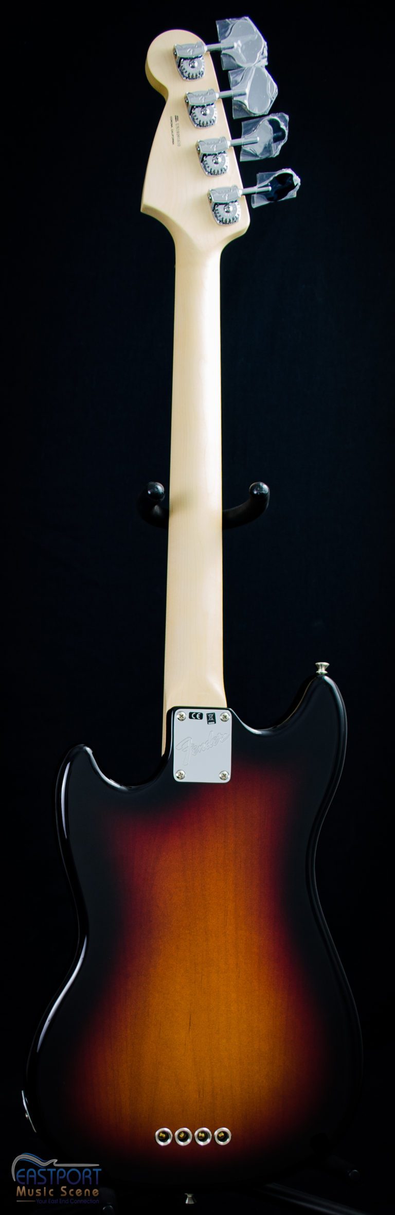 A guitar with the back of it turned to the side.