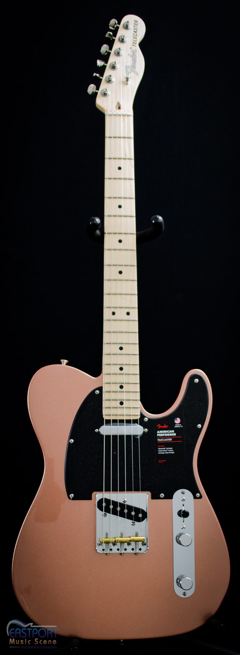 A pink guitar with black headstock and neck