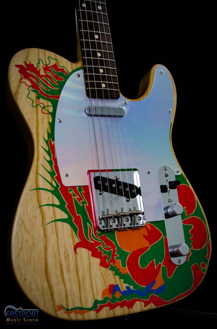 A guitar with some colorful designs on it