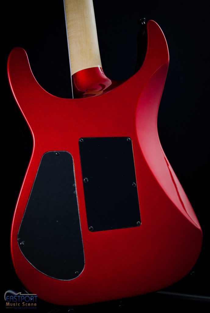 A red guitar with black trim and a white handle.