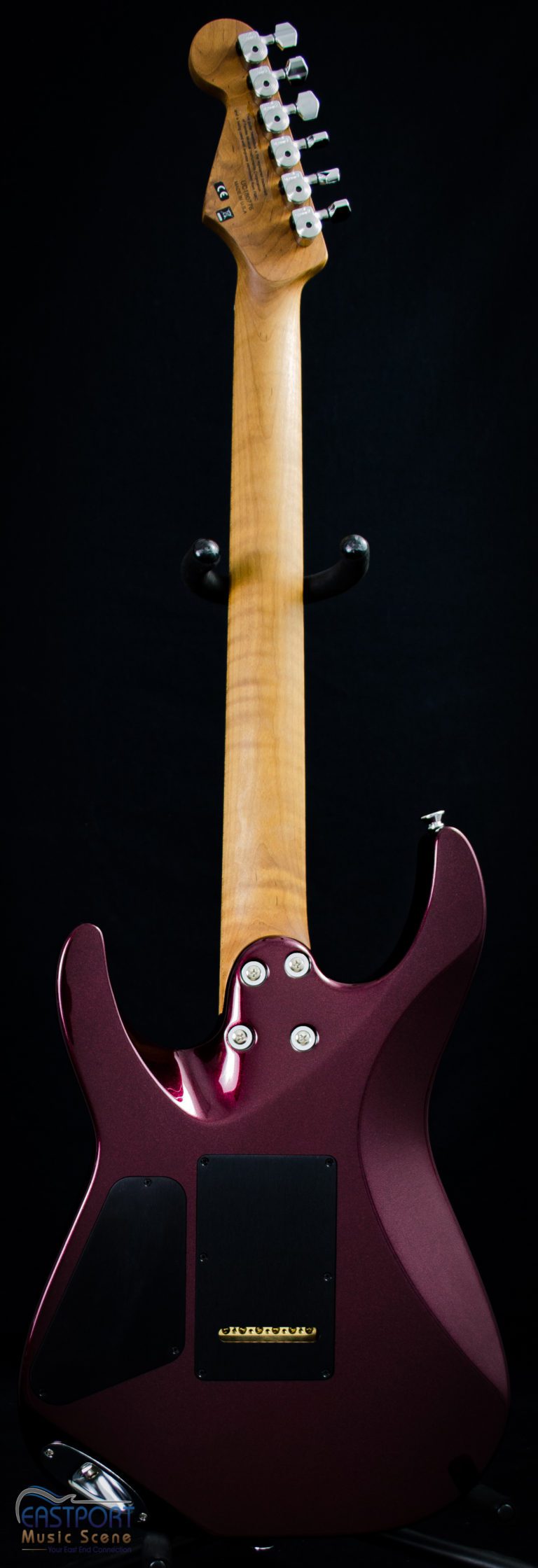 A close up of the neck and back of an electric guitar.