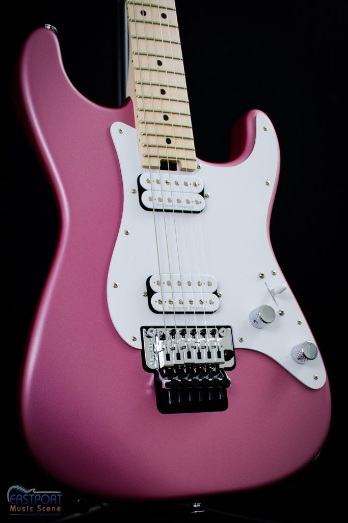 A pink electric guitar with white knobs and strings.