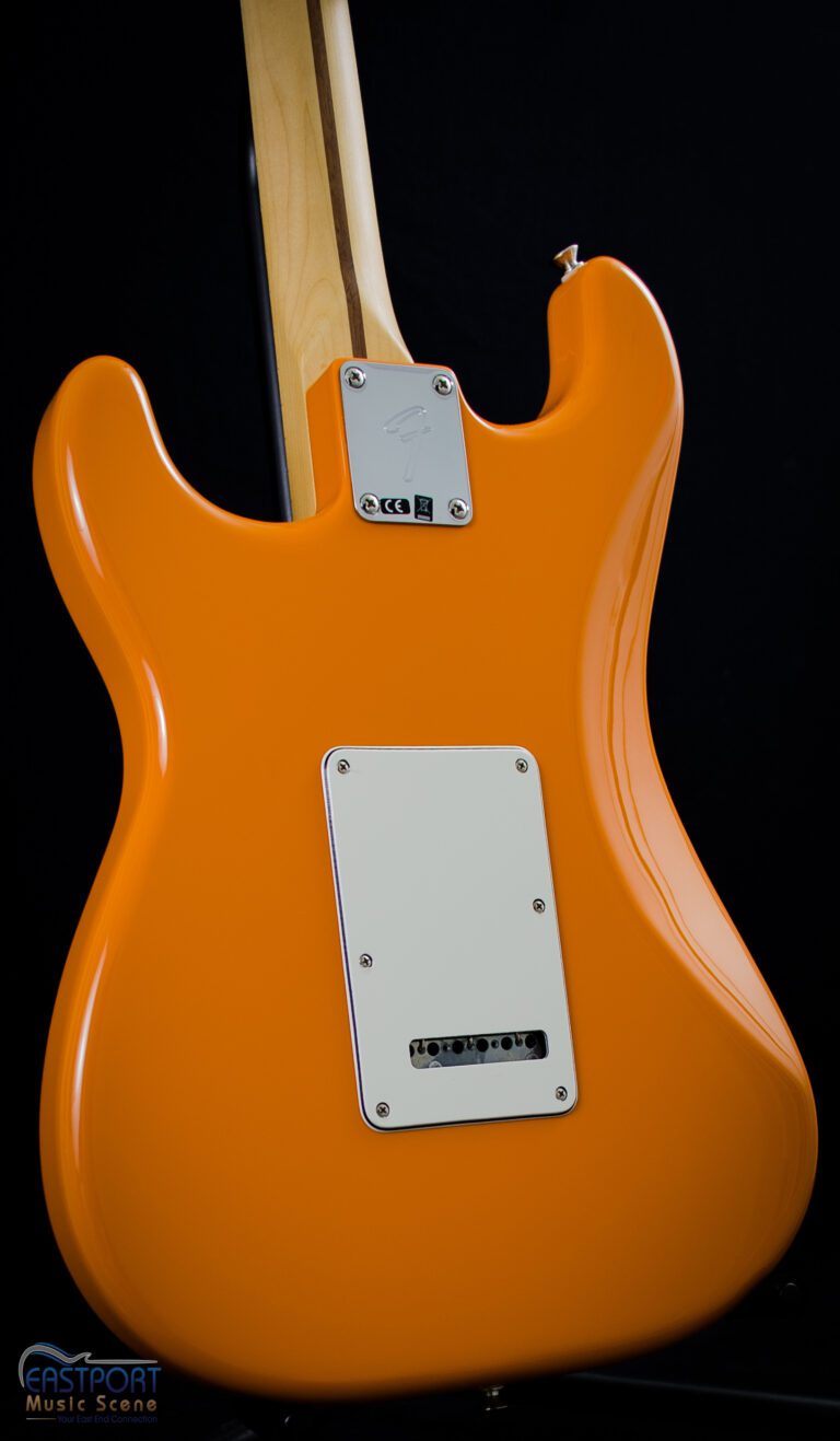A close up of the back end of an orange guitar