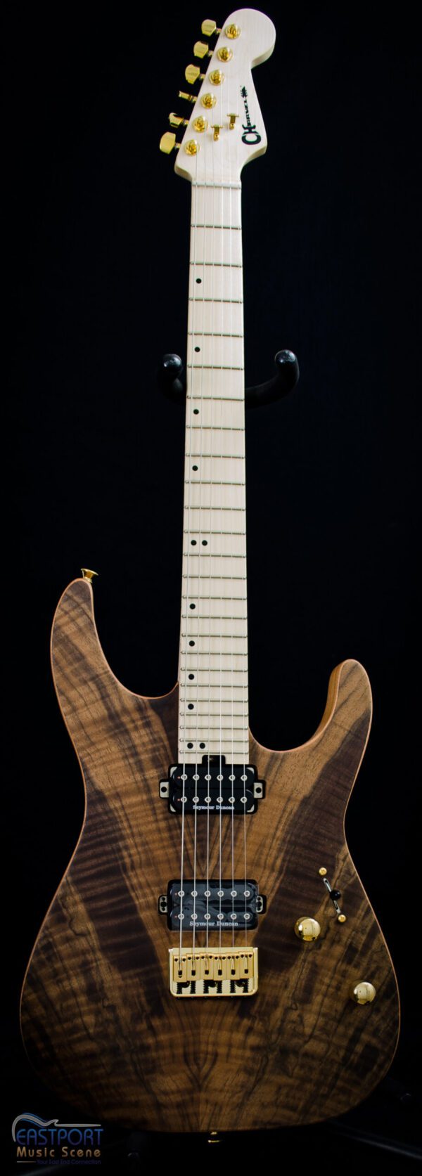 A guitar with a wooden body and white strings.