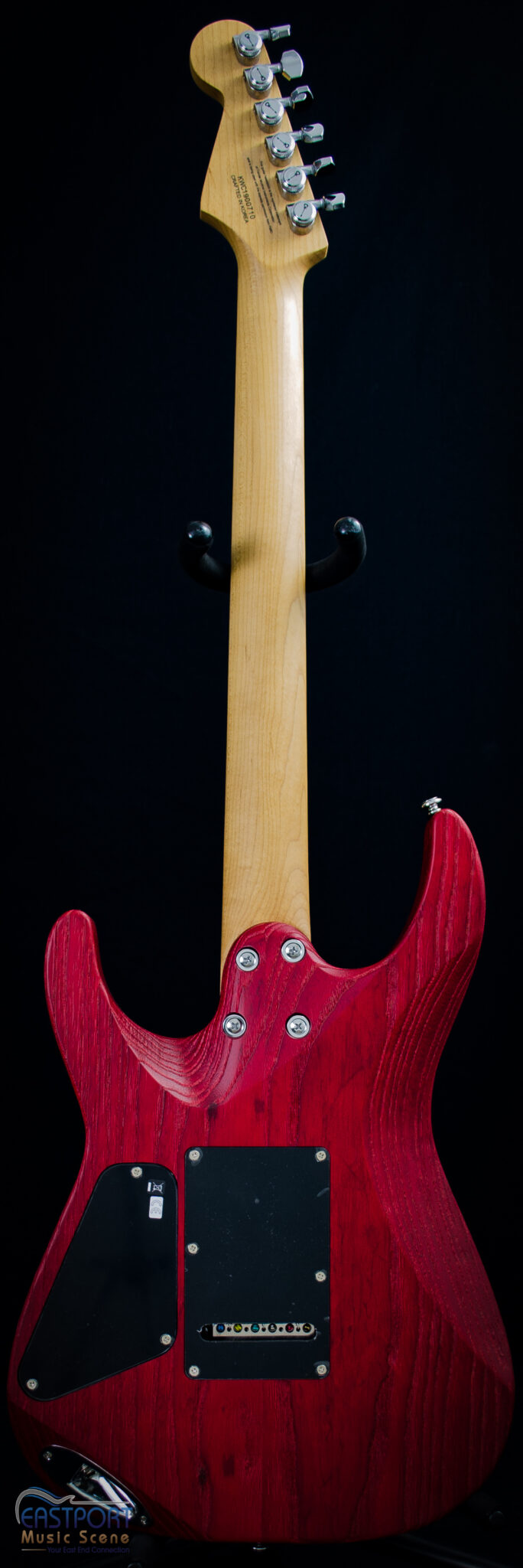 A red electric guitar with a black background