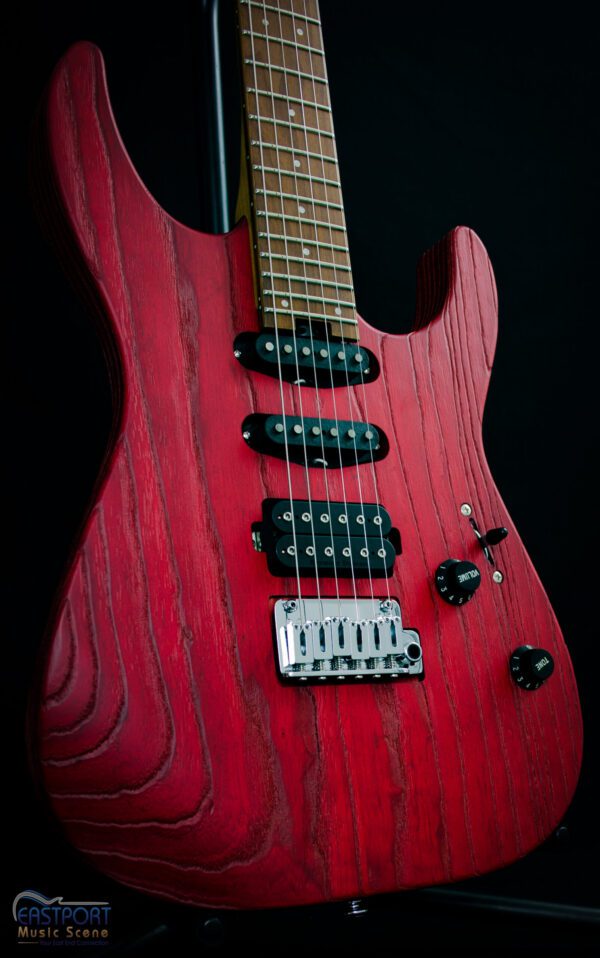 A red electric guitar with black wood grain.