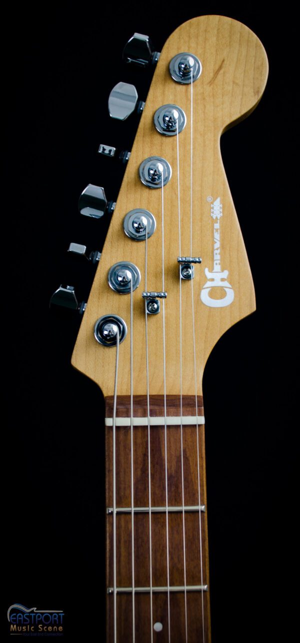 A close up of the neck and headstock on an electric guitar.