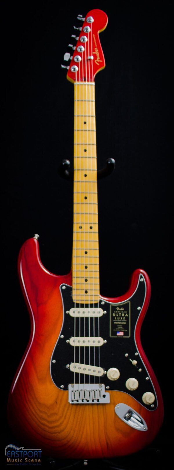 A red and yellow electric guitar is on display.